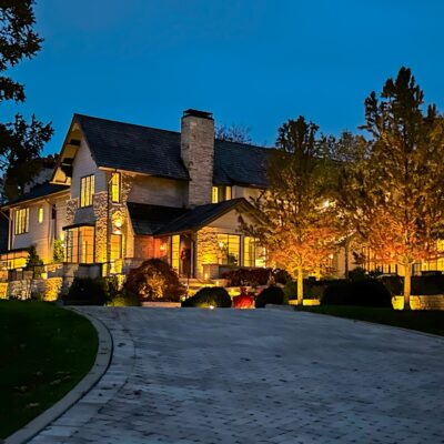 luxury home with landscape lighting at dusk